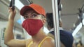 Woman travel caucasian ride at overground train airtrain with wearing protective medical mask. Girl tourist at airtrain Royalty Free Stock Photo