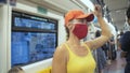 Woman travel caucasian ride at overground train airtrain with wearing protective medical mask. Girl tourist at airtrain Royalty Free Stock Photo