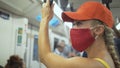 Woman travel caucasian ride at overground train airtrain with wearing protective medical mask. Girl tourist at airtrain Royalty Free Stock Photo