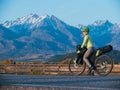 The woman travel on mixed terrain cycle touring with bikepacking. The traveler journey with bicycle bags. Sport tourism