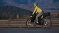 The woman travel on mixed terrain cycle touring with bikepacking. The traveler journey with bicycle bags. Sport tourism