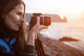 Woman travel sea. Happy tourist enjoy taking picture outdoors for memories. Woman traveler looks at sea bay of mountains