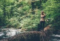 Woman Traveler alone crossing over river on woods