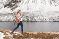 Woman traveler on the background of a mountain lake