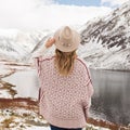 Woman traveler on the background of a mountain lake