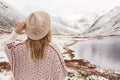 Woman traveler on the background of a mountain lake