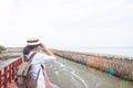 Woman traveler with backpack enjoying seaside with sunset