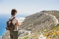 Woman traveler with backpack holding map. Travel, tourism, summer holidays, active lifestyle concept. Hipster tourist girl looking Royalty Free Stock Photo