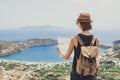 Woman traveler with backpack holding map. Travel, tourism, summer holidays, active lifestyle concept. Hipster tourist girl looking Royalty Free Stock Photo