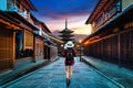 Woman traveler with backpack walking at Yasaka Pagoda and Sannen Zaka Street in Kyoto, Japan. Royalty Free Stock Photo