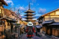 Woman traveler with backpack walking at Yasaka Pagoda and Sannen Zaka Street in Kyoto, Japan