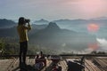Woman traveler camping take a photo in Mountains with Beautiful summer