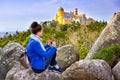 Woman traveler enjoying famous landscape and Palace of Pena, Sintra, Lisboa Royalty Free Stock Photo