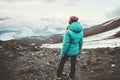 Woman traveler enjoying foggy mountains landscape