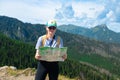 Woman traveler explorer with backpack hiking to the top of the mountain.Shot of a young lost woman holding a map while