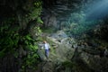 Woman traveler explores beautiful Hang Tien Cave in Phong Nha Ke National Park. Vietnam