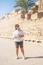 Woman traveler explores the ruins of the ancient Karnak temple in the city of Luxor in Egypt. Royalty Free Stock Photo