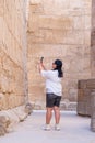 Woman traveler explores the ruins of the ancient Karnak temple in the city of Luxor in Egypt. Royalty Free Stock Photo