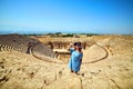 Woman traveler in hat looking at amazing Amphitheater ruins in ancient Hierapolis, Pamukkale, Turkey. Grand panoramic view Royalty Free Stock Photo