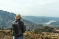 Woman traveler with a hat standing on a background of green mountains Royalty Free Stock Photo