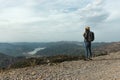 Woman traveler with a hat standing on a background of green mountains Royalty Free Stock Photo