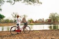 Woman traveler have early morning bicykle walk near ancient ruins of Ayutthaya, Thailand