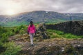 Woman traveler hiking across Iceland landscape