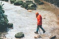 Woman Traveler hiking crossing stream