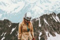 Woman traveler hiking in mountains with helmet gear