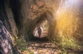 Woman Traveler hiking in a rocky tunnel Travel