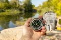 Woman traveler holding a compass in her hand in the summer mountains at dawn. Royalty Free Stock Photo