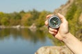 Woman traveler holding a compass in her hand in the summer mountains at dawn. Royalty Free Stock Photo