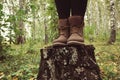 Traveler legs in leather brown boots in forest