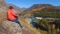 Woman traveler looking at natural canyon with view of the mountain river. Concept of travel.