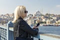 Woman traveler looks on beautiful view Istanbul city, Turkey.