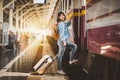 Woman traveler with luggage getting on the train Royalty Free Stock Photo