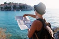 Woman traveler with map near Adriatic Sea