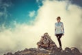 Woman Traveler on Mountain Summit with stones Royalty Free Stock Photo