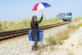 Woman traveler at a passing train