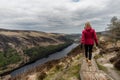 Woman traveler in a red jacket in the Spink Viewing Spot in Wicklow mountains national park, Ireland Royalty Free Stock Photo