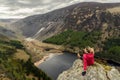 Woman traveler in a red jacket in the Spink Viewing Spot in Wicklow mountains national park, Ireland Royalty Free Stock Photo