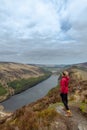 Woman traveler in a red jacket in the Spink Viewing Spot in Wicklow mountains national park, Ireland Royalty Free Stock Photo