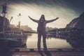 Woman traveler in Reine village with arms wide open Royalty Free Stock Photo