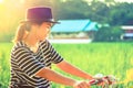 Woman traveler ride bicycle with paddy background.