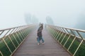 Woman Traveler sightseeing Golden bridge at the top of the Ba Na Hills. Landmark and popular. Vietnam and Southeast Asia travel