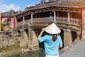 Woman traveler sightseeing at Japanese covered bridge or Cau temple in Hoi An ancient town, Vietnam. landmark and popular for Royalty Free Stock Photo