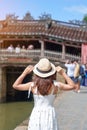 Woman traveler sightseeing at Japanese covered bridge or Cau temple in Hoi An ancient town, Vietnam. landmark and popular for Royalty Free Stock Photo