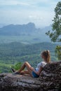 Woman traveler sitting on the cliff