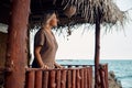 Woman Traveler Stand on Wooden Bungalow Balcony