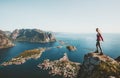 Woman traveler standing alone on cliff edge in Norway Royalty Free Stock Photo